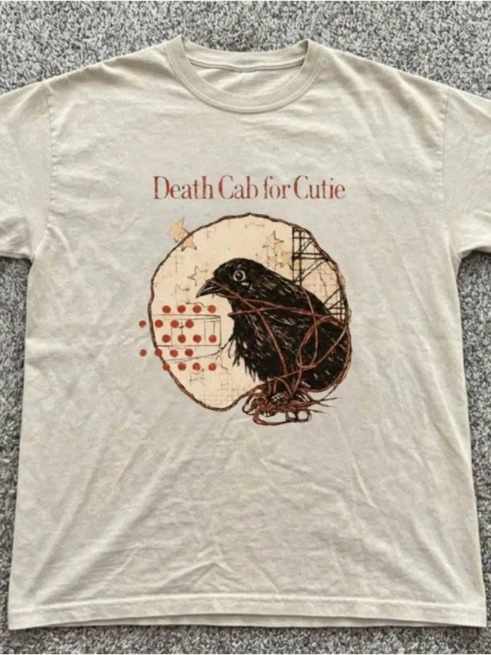Beige Graphic Tee with Black Crow and Red Accents